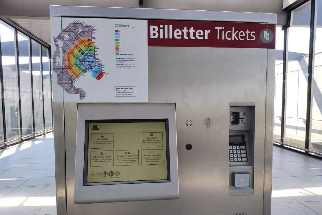 A silver grey ticket machine for purchasing metro tickets at Copenhagen Airport